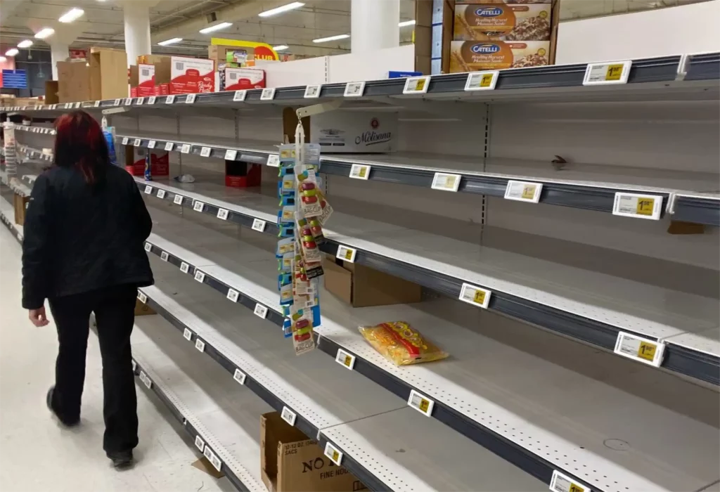 A row of empty supermarket shelves