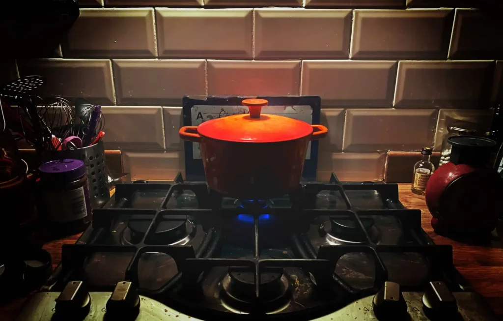 A pot of stew simmering on a gas hob